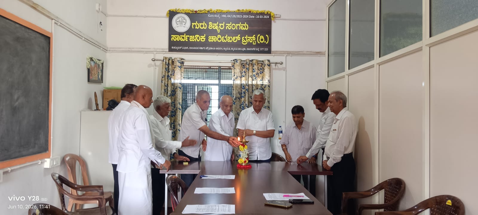 Trustees gathered at the meeting table during the lamp-lighting ceremony