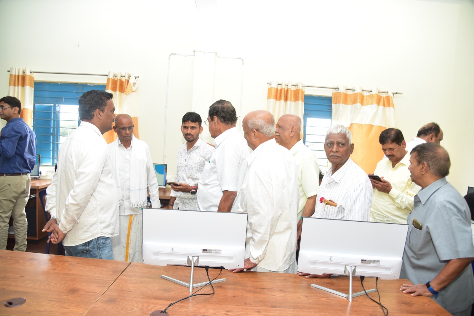 Trustees and guests gathered around the new monitors