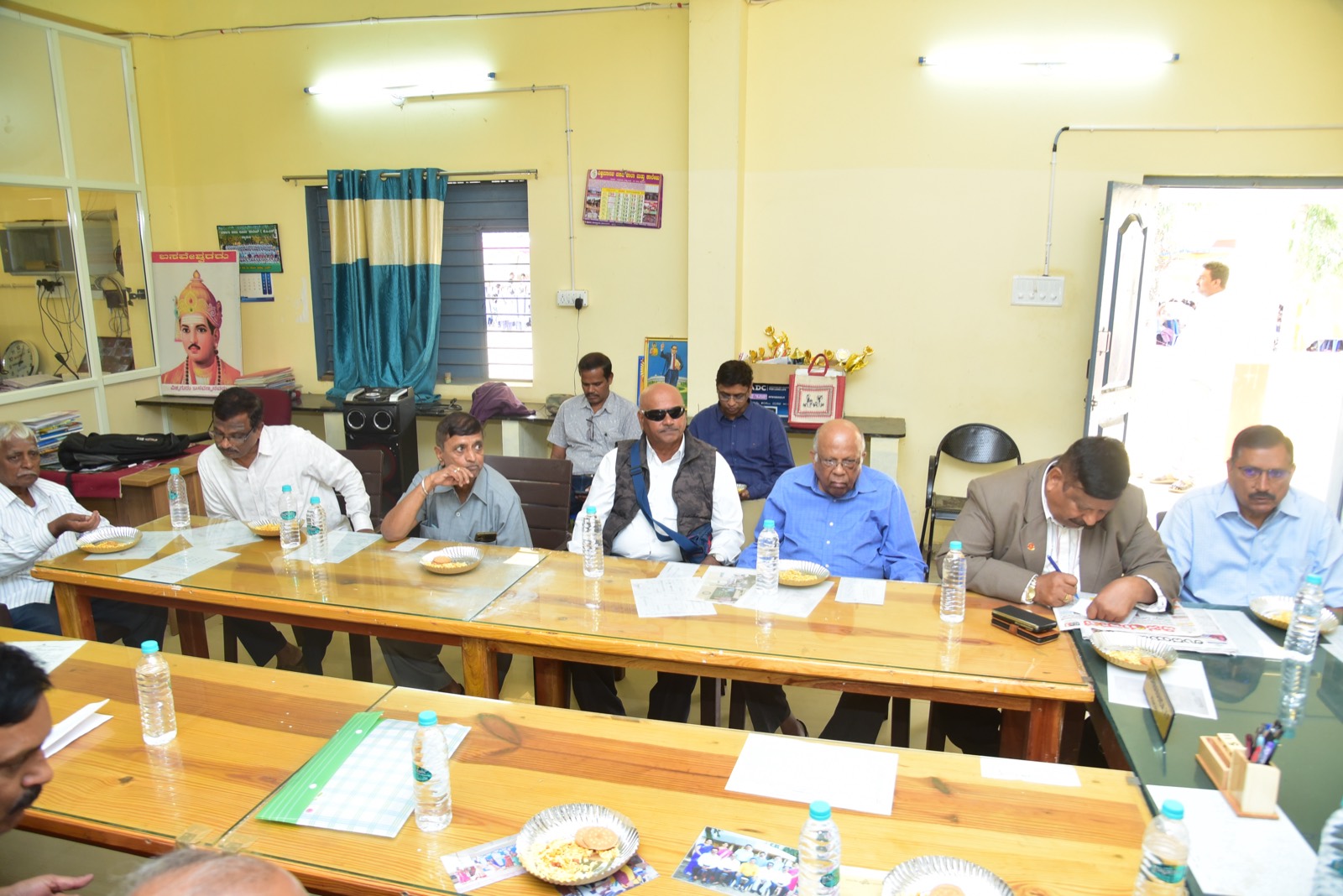 Trustees and school staff seated around a long meeting table
